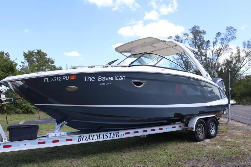 Slide: The Image of 2019 Regal 29 OBX boat on trailer, labeled "The Bavarian," Cape Coral. - 1