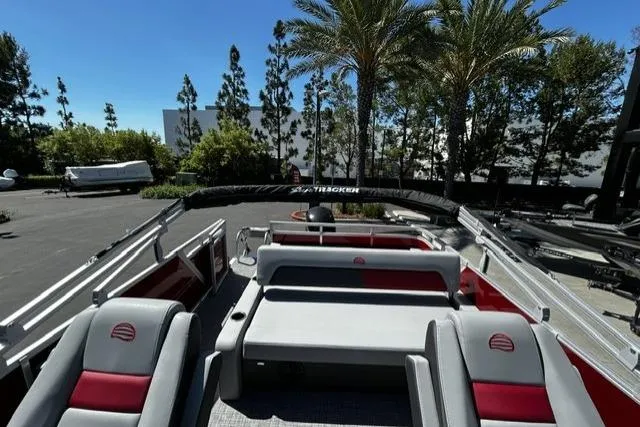 Slide: The Image of 2026 Sun Tracker Party Barge 22 RF XP3 pontoon boat with seating, parked outdoors. - 8