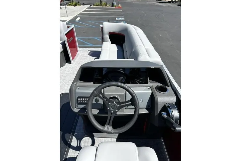 Slide: The Image of 2026 Sun Tracker Party Barge 22 RF XP3 interior with steering wheel and seating. - 7