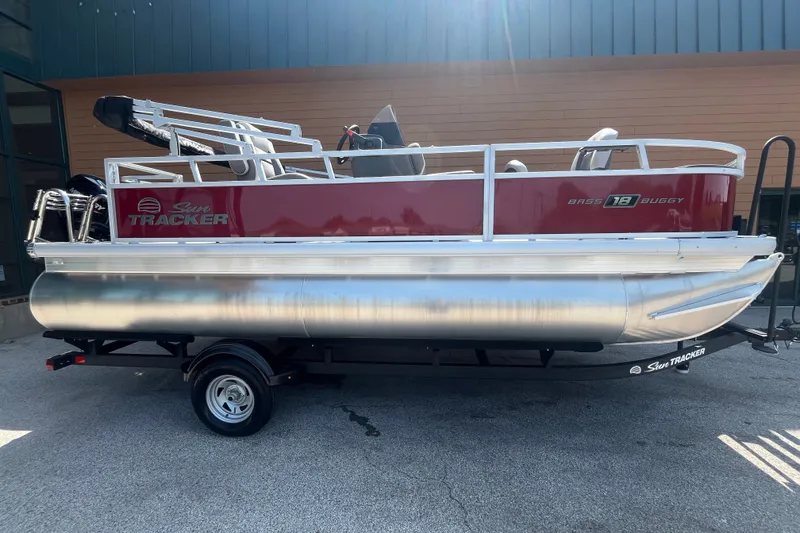 The Image of 2026 Sun Tracker Bass Buggy 18 DLX pontoon boat on trailer, side view. - 0