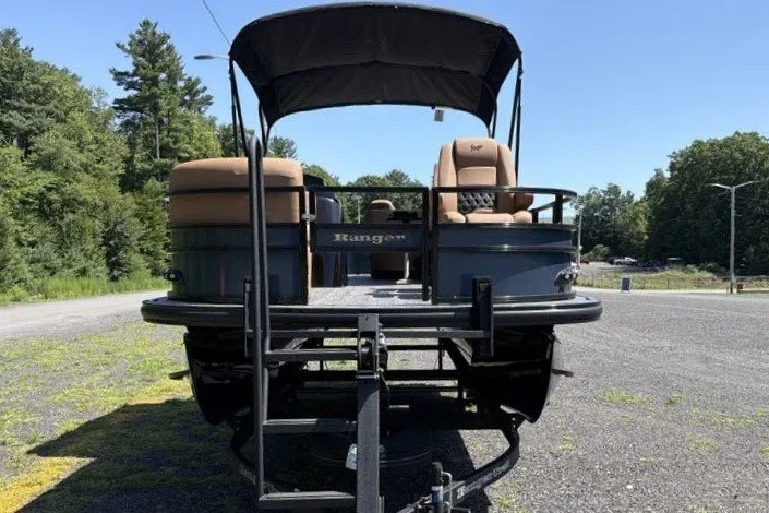 Slide: The Image of 2026 Ranger 220FC boat on trailer, parked outdoors under clear sky. - 6