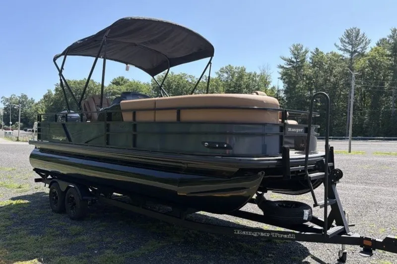 Slide: The Image of 2026 Ranger 220FC pontoon boat on trailer with canopy, parked outdoors. - 2