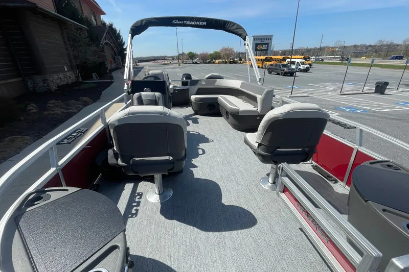 Slide: The Image of 2026 Sun Tracker Bass Buggy 18 DLX pontoon boat with spacious seating and modern design. - 2