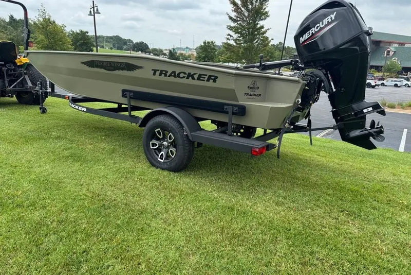 The Image of 2026 Tracker Grizzly 1650 T Prairie Wings Edition boat on trailer, parked on grass. - 0