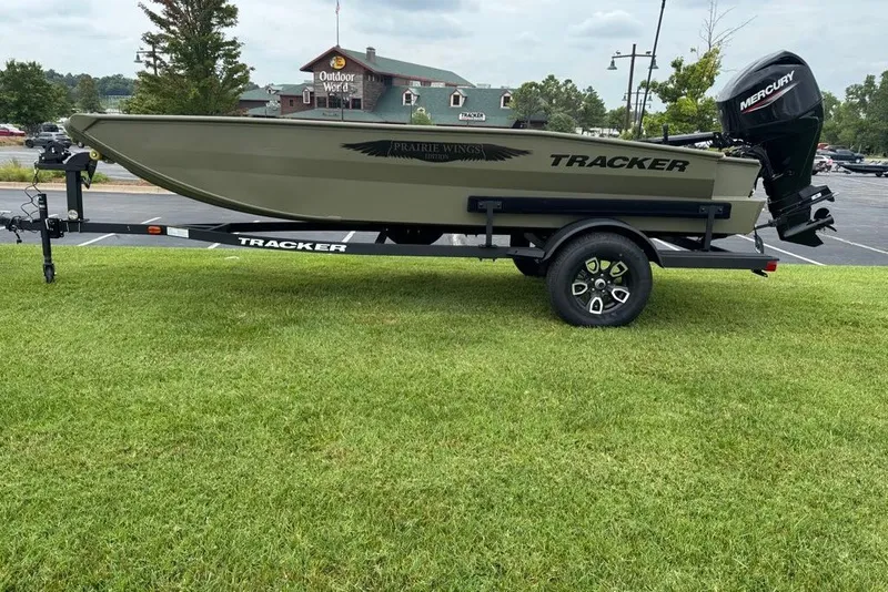 Slide: The Image of 2026 Tracker Grizzly 1650 T Prairie Wings Edition boat on trailer, parked on grass. - 3