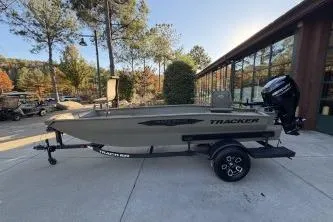 Slide: The Image of 2026 Tracker Grizzly 1650 T Prairie Wings Edition boat on trailer, parked outdoors. - 4