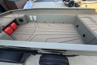 Slide: The Image of 2026 Tracker Grizzly 1650 T Prairie Wings Edition boat interior with storage compartments. - 3