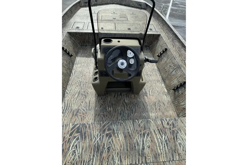 Slide: The Image of 2026 Tracker Grizzly 2072 CC boat interior with camouflage design and steering console. - 6