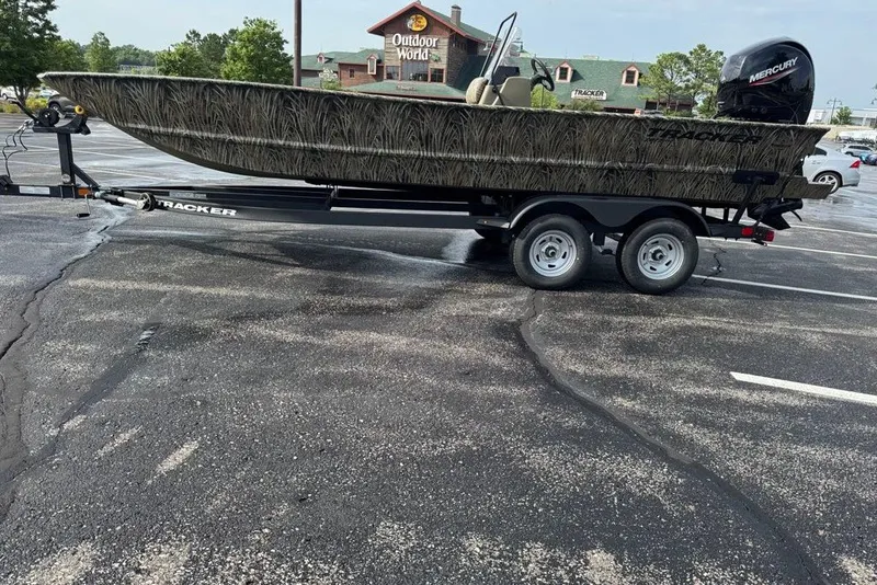 Slide: The Image of 2026 Tracker Grizzly 2072 CC boat on trailer in parking lot near Outdoor World. - 2