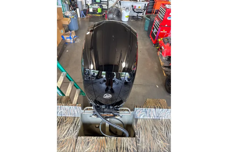 Slide: The Image of 2026 Tracker Grizzly 2072 CC boat engine in a workshop setting. - 8