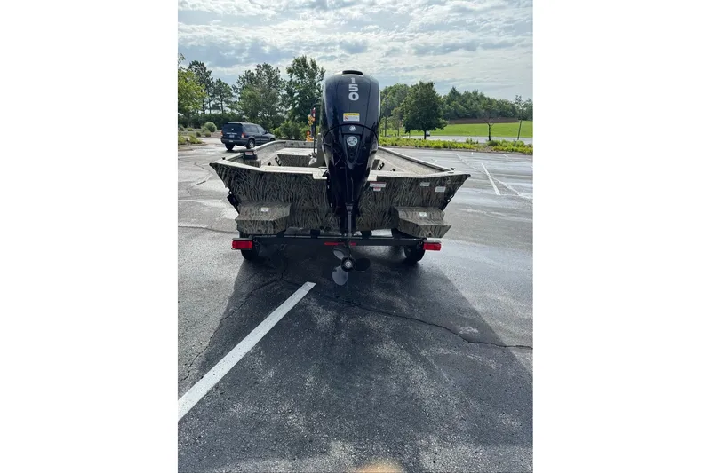 Slide: The Image of 2026 Tracker Grizzly 2072 CC boat on trailer in parking lot, rear view. - 7