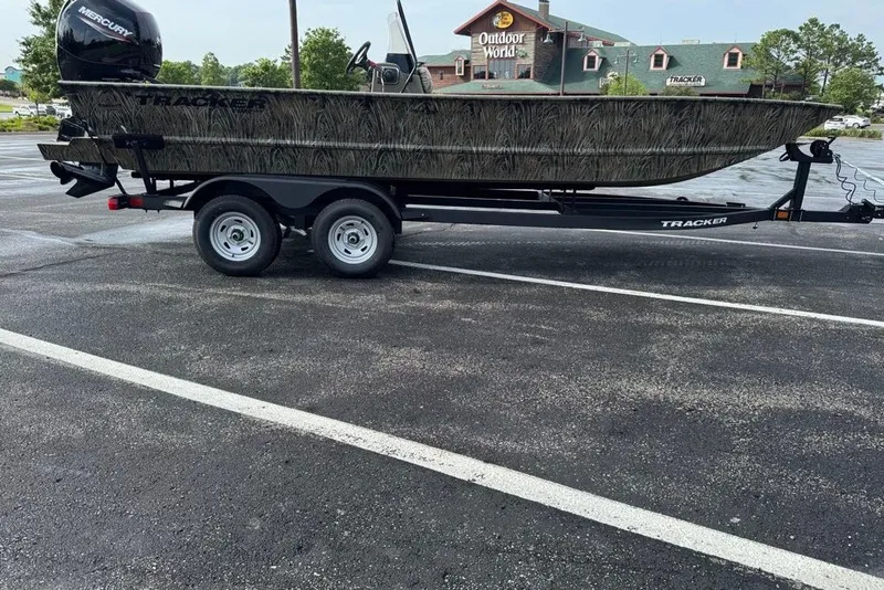 The Image of 2026 Tracker Grizzly 2072 CC boat on trailer in parking lot near Outdoor World. - 0