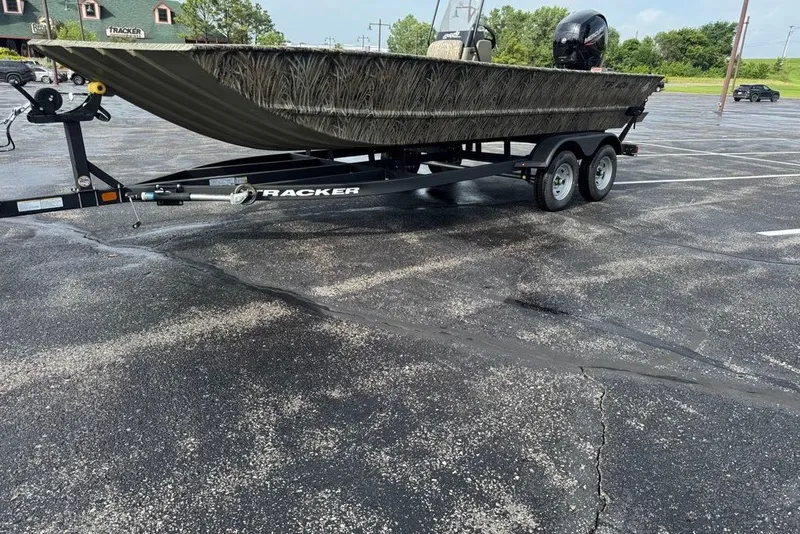Slide: The Image of 2026 Tracker Grizzly 2072 CC boat on trailer in parking lot. - 11