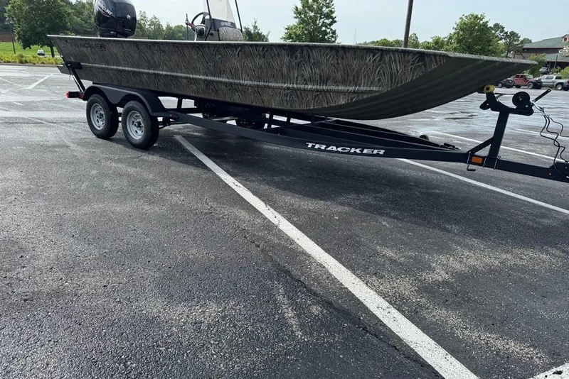 Slide: The Image of 2026 Tracker Grizzly 2072 CC boat on trailer in parking lot. - 12