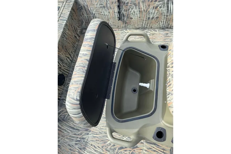 Slide: The Image of 2026 Tracker Grizzly 2072 CC boat with open storage compartment, camo interior design. - 5