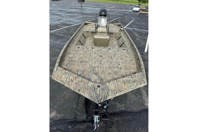 Slide: The Image of 2026 Tracker Grizzly 2072 CC boat with camouflage design in a parking lot. - 4