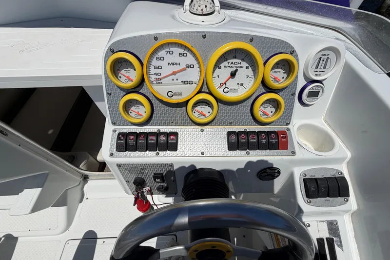 Slide: The Image of Dashboard of a 2002 Baja 25 Outlaw boat with gauges and controls. - 20