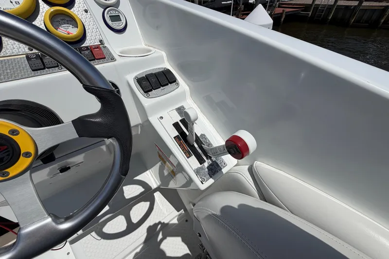 Slide: The Image of 2002 Baja 25 Outlaw boat cockpit with steering wheel and control panel. - 18