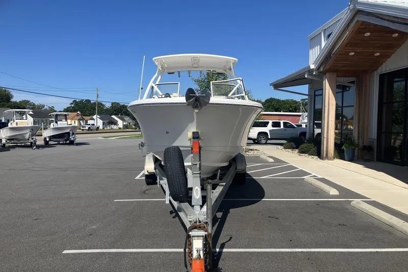 Slide: The Image of 2018 Edgewater 248CX Crossover boat on trailer in parking lot, sunny day. - 3