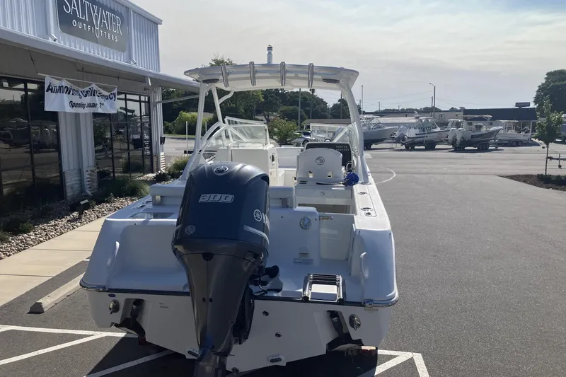 Slide: The Image of 2018 Edgewater 248CX Crossover boat parked outside Saltwater Outfitters store. - 6