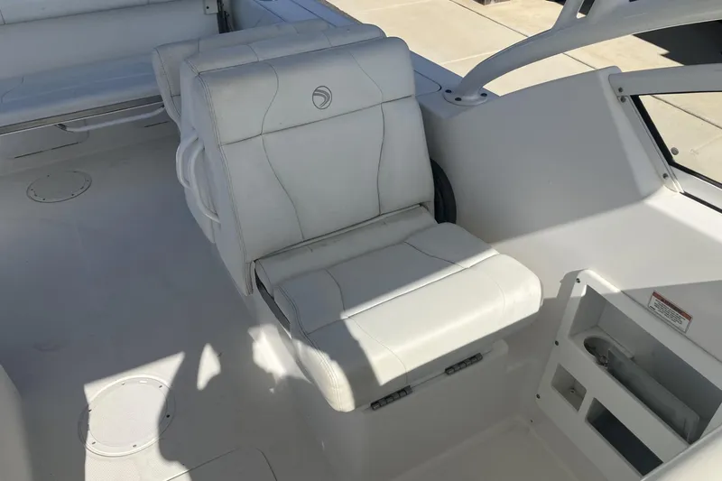 Slide: The Image of 2018 Edgewater 248CX Crossover boat interior with white seating and modern design. - 19