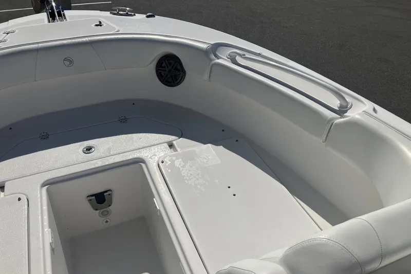 Slide: The Image of 2018 Edgewater 248CX Crossover boat interior, featuring spacious seating and storage compartments. - 13