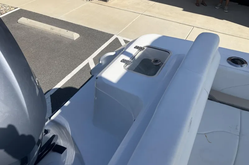 Slide: The Image of 2018 Edgewater 248CX Crossover boat interior with seating and storage compartment. - 16