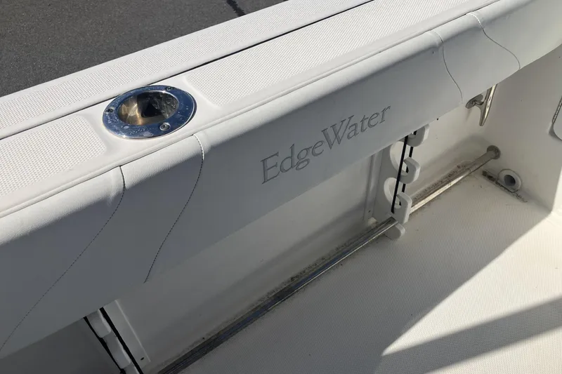 Slide: The Image of 2018 Edgewater 248CX Crossover boat interior with rod holder and logo detail. - 17