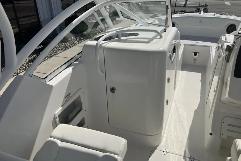 Slide: The Image of 2018 Edgewater 248CX Crossover boat interior with white seating and sleek design. - 9