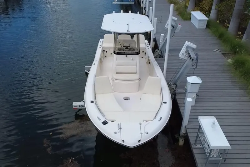 Slide: The Image of 2021 Grady-White 251 Coastal Explorer docked, showcasing sleek design and spacious seating. - 4