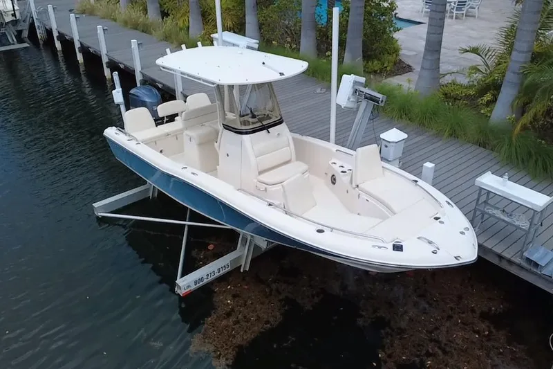 Slide: The Image of 2021 Grady-White 251 Coastal Explorer boat docked near palm trees. - 3