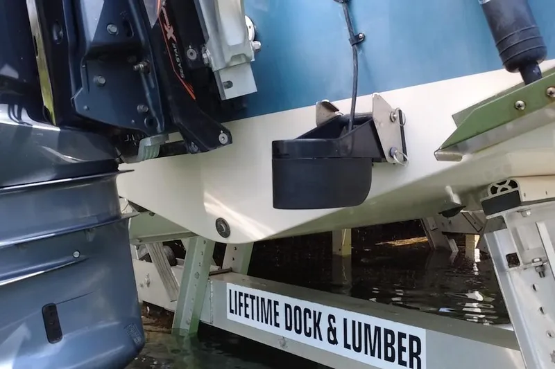 Slide: The Image of 2021 Grady-White 251 Coastal Explorer boat on dock, featuring motor and hull details. - 8
