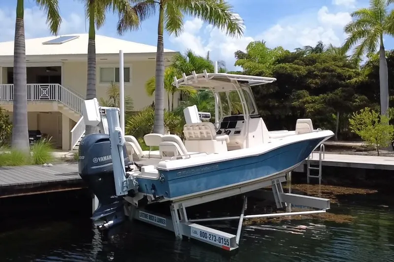 Slide: The Image of 2021 Grady-White 251 Coastal Explorer boat docked near a tropical waterfront home. - 12
