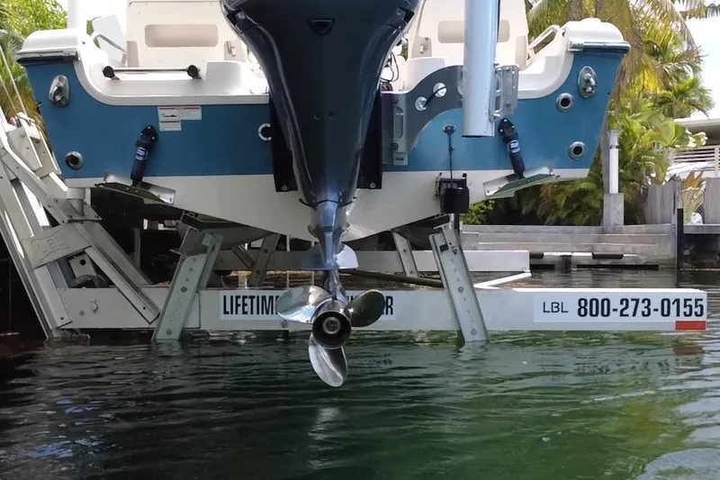 Slide: The Image of 2021 Grady-White 251 Coastal Explorer on boat lift, rear view with motor. - 6