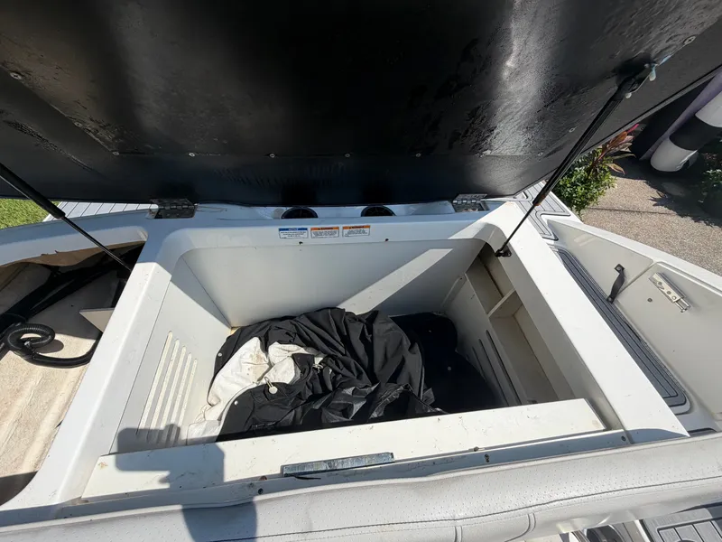Slide: The Image of An open storage compartment on a 2021 Sea Ray SPX 210 Outboard boat. - 15