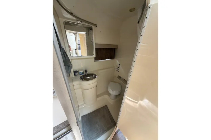 Slide: The Image of 2002 Formula 27 Performance Cruiser bathroom with sink, mirror, and toilet. - 18