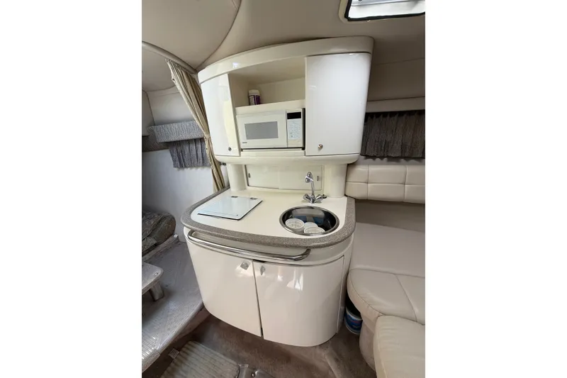 Slide: The Image of Compact kitchenette in 2002 Formula 27 Performance Cruiser with microwave, sink, and storage. - 14