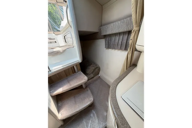 Slide: The Image of Interior of 2002 Formula 27 Performance Cruiser with carpeted steps and compact design. - 16