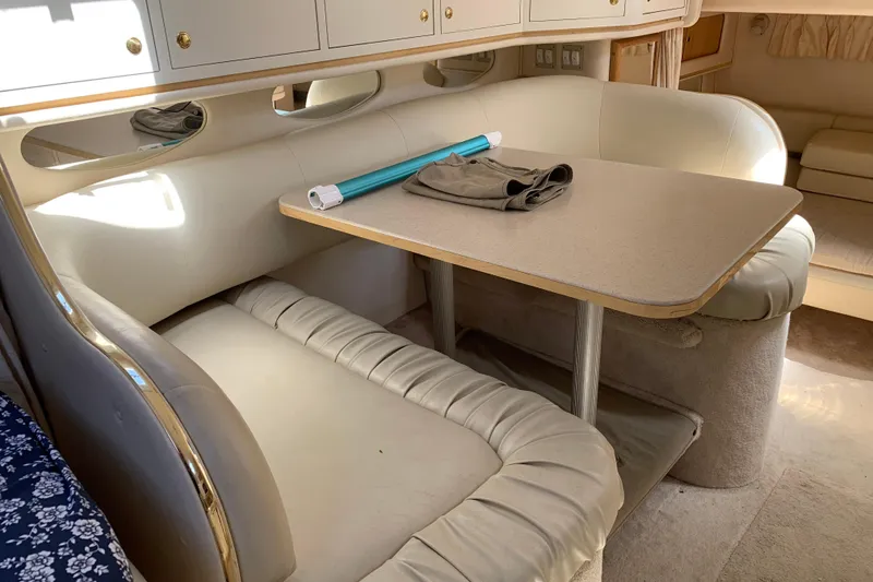 Slide: The Image of Interior of 2000 Sea Ray Sundancer 310 with beige seating and dining table. - 24