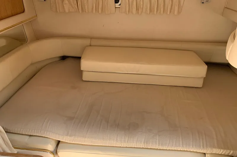 Slide: The Image of Interior cabin of 2000 Sea Ray Sundancer 310 with beige seating and cushions. - 26