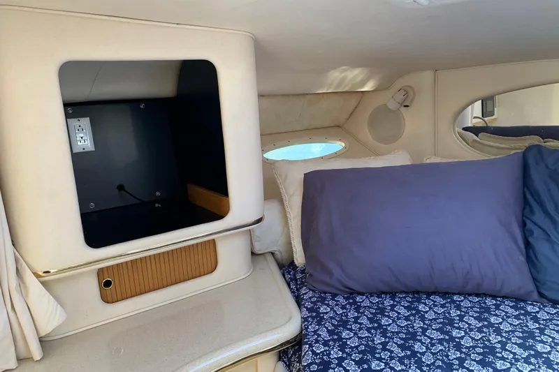 Slide: The Image of Interior cabin of 2000 Sea Ray Sundancer 310 with bed and storage space. - 33