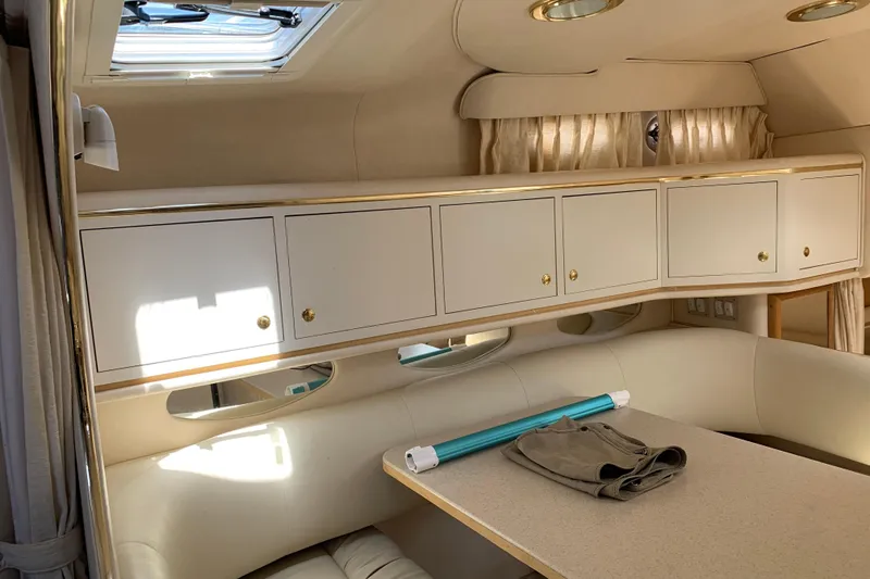 Slide: The Image of Interior of 2000 Sea Ray Sundancer 310 yacht with seating and storage cabinets. - 25