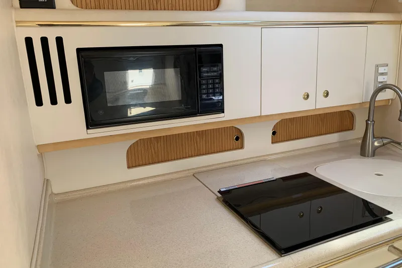 Slide: The Image of Kitchen area of a 2000 Sea Ray Sundancer 310 with microwave and sink. - 28