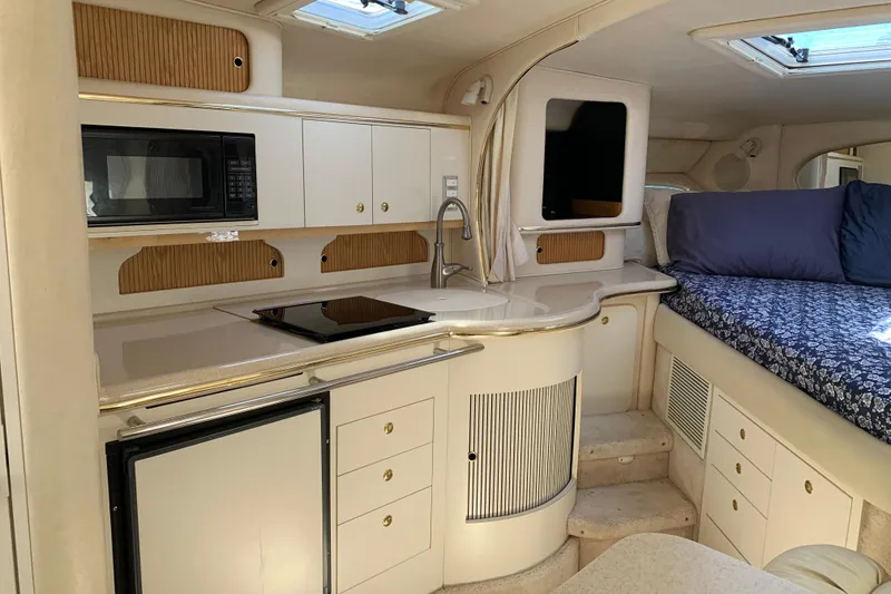 Slide: The Image of Interior of 2000 Sea Ray Sundancer 310 yacht with kitchenette and cozy sleeping area. - 27