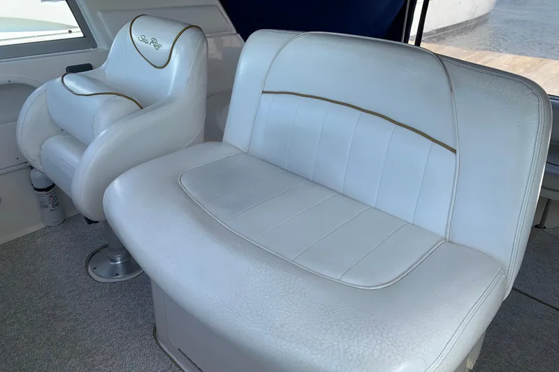 Slide: The Image of White leather seating on a 2000 Sea Ray Sundancer 310 boat interior. - 21