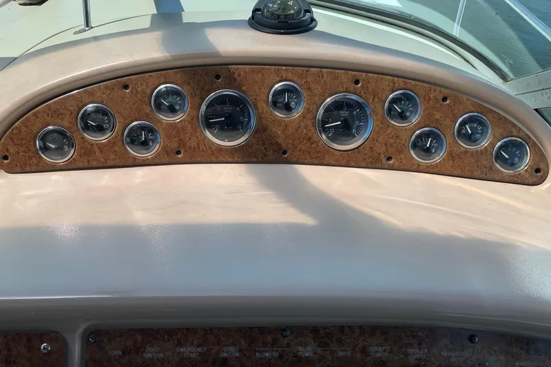 Slide: The Image of Dashboard of a 2000 Sea Ray Sundancer 310 boat with multiple gauges and wood paneling. - 20