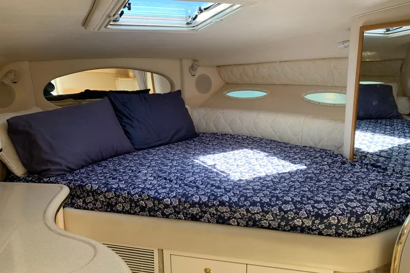 Slide: The Image of Cozy cabin interior of 2000 Sea Ray Sundancer 310 with floral bedding and skylight. - 23