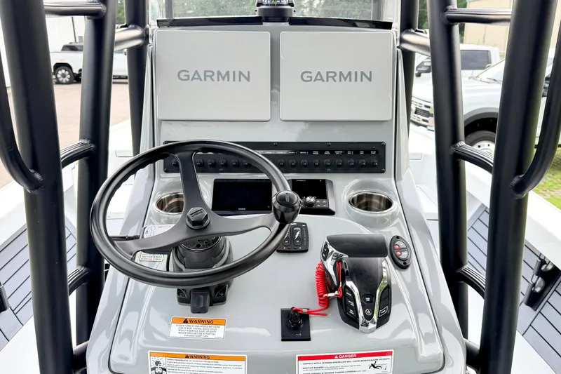 Slide: The Image of 2026 Pathfinder 2500 Hybrid boat console with Garmin displays and steering wheel. - 17