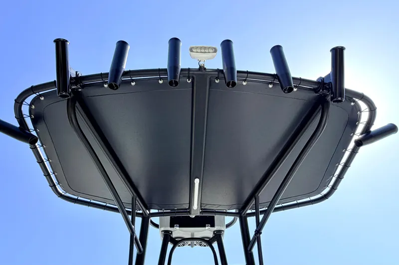 Slide: The Image of T-top view of 2026 Pathfinder 2500 Hybrid boat against clear blue sky. - 23