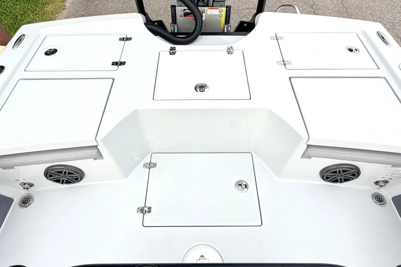 Slide: The Image of 2026 Pathfinder 2500 Hybrid boat deck with storage compartments and speakers. - 11